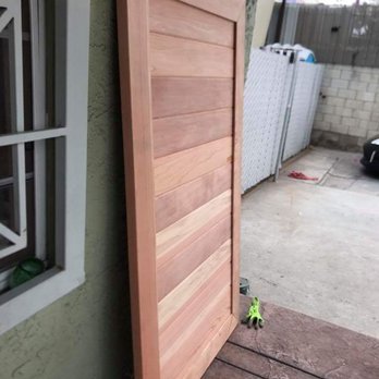 A wooden door is open on a house