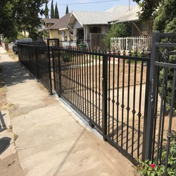 A black iron fence in front of a house