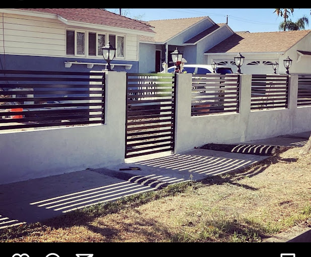 A house with a fence and a car parked in front of it