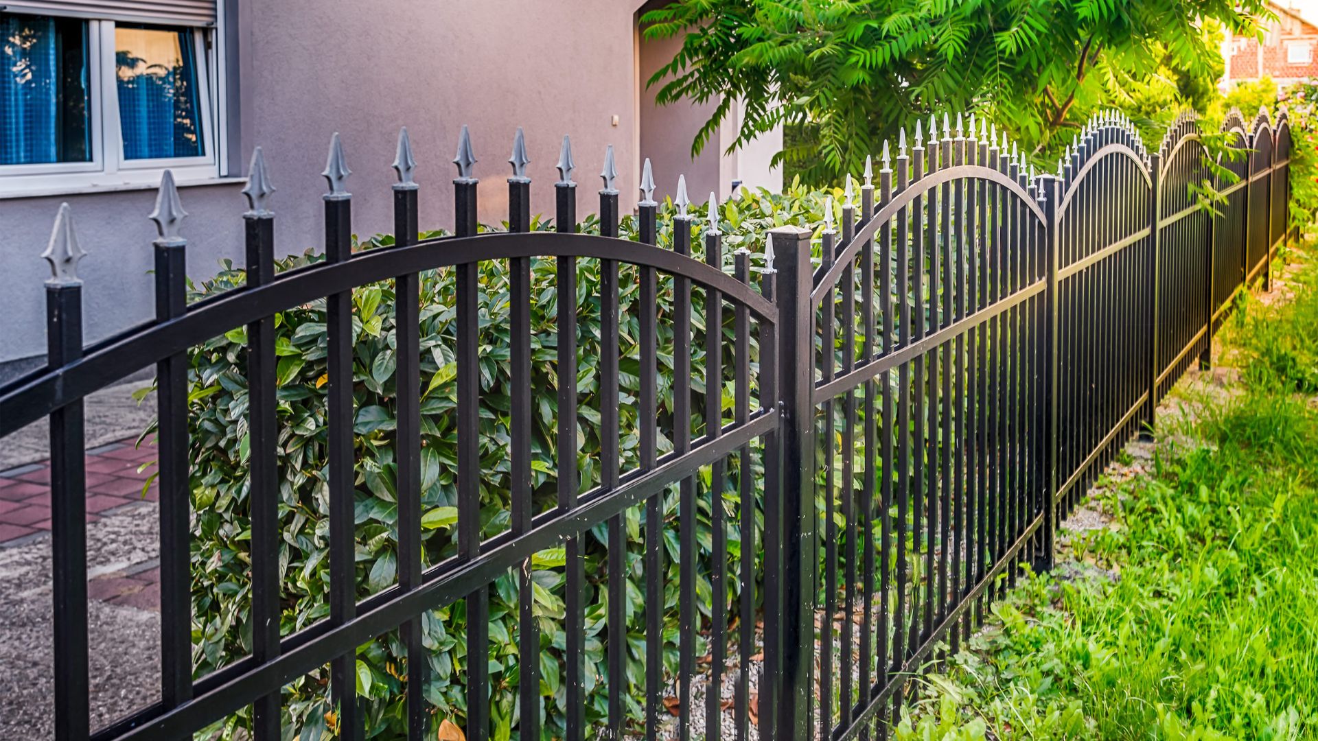 A black iron fence in front of a house