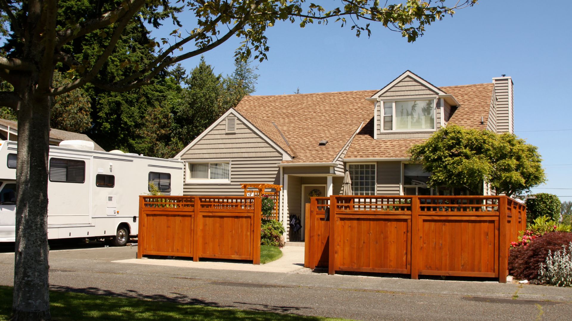 A house with a brown fence in front of it